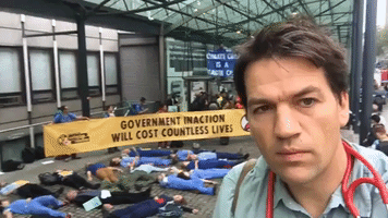 Doctors Glue Themselves to Government Building in London in Climate Protest