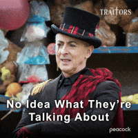 Sponsored gif. Alan Cumming as host of in a top hat, black suit, and red sash looks confused and shakes his head. Text reads, “No idea what they’re talking about.” 