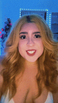 Video gif. A woman looks at us and grooves to music as lights flash in the background. She says, "Me paga los biles," which appears as text.