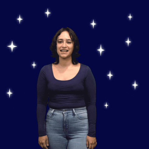Video gif. Woman yawns and covers her mouth with both hands as she stands in front of a navy background with glittering stars. Then she stretches and says," Buenos Noches," which transforms from a cloud into text.