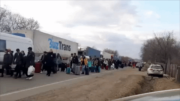 Ukrainian Refugees Fleeing to Romania Gather at Border Crossing