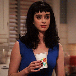 TV gif. Krysten Ritter as Chloe on Don’t Trust the B in Apartment 23 holds a plastic cup in her hand. She lights up in excitement, her eyes getting big and her mouth opening wide into a big smile.