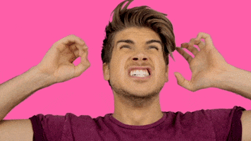 Celebrity gif. Joey Graceffa raises his hands by his head as he screams angrily.