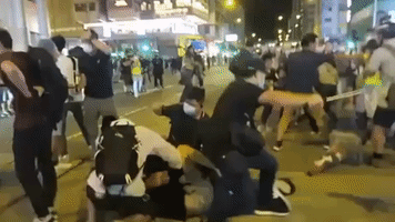 Plainclothes Officers Pin Demonstrators to Ground Following Tiananmen Square Vigil