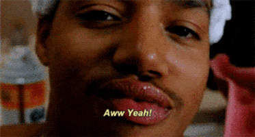 Movie gif. Close up of Donald Faison as Murray in Clueless. He nods coolly and lips his braces on his teeth, and smiles smugly. He says, “aww yeah!”
