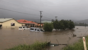Vehicles Maneuver Through Floodwaters as Torrential Rain Drenches New South Wales
