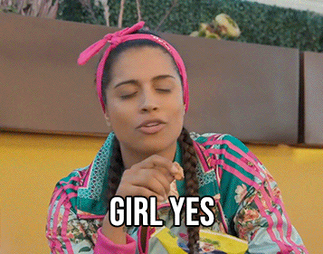 Celebrity gif. Lily Singh wearing brightly colored clothes snacks on chips while sassily agreeing with a smirk on her face, saying “girl yes.