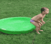Video gif. In a clip from AFV, a child in a bathing suit prepares to drop into a seated position onto the side of a full plastic kiddie pool, ostensibly tipping it over...but instead they just land on the ground. The child looks at us with surprise.
