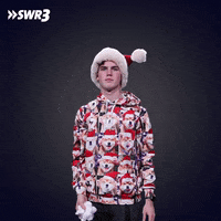 Celebrity gif. Media personality Marcel Bihl in a Santa hat and Christmas sweater throws a handful of fake snow over his head with a flat, joyless expression.