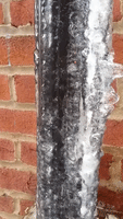 Waterfall Flows Inside Frozen Pipe as Ice Melts