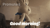 Sponsored gif. Pillsbury Doughboy spins happily while people around him eat breakfast. Text reads, "Good morning!"