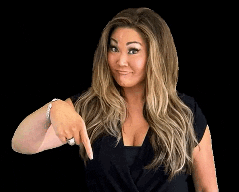 Video gif. A woman pouts her lips and raises her eyebrows while nodding and pointing down.