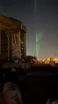Lasers Light Up Baghdad's Tahrir Square as Thousands of Protesters Mass