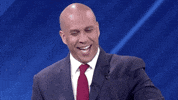Video gif. Cory Booker stands behind a microphone as he smiles smugly and speaks to someone unseen. Text, "First of all I want to say no. Actually, I want to translate that into Spanish. No."