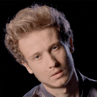 Video gif. An annoyed man looks bored and rolls his eyes as if to say, “Are you kidding me?”