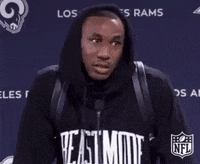 Sports gif. Marcus Peters from the LA Rams is being interviewed and he gives a big shrug of his shoulders and face scrunch while shaking his head.