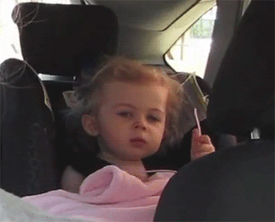 Video gif. A baby in a car seat looks peeved, rolling her eyes and knocking her head back.