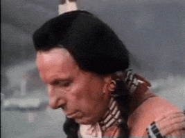 Video gif. A Native American man is looking forlorn as he stares downwards. He looks up at us sharply and the camera zooms in on his eye.