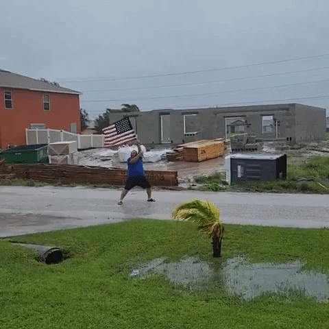 Florida Man Poses With US Flag In Hurricane Ian