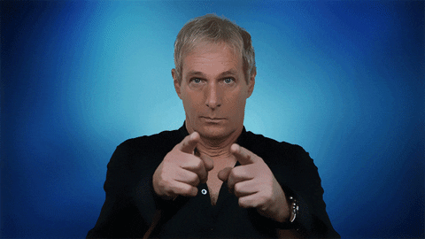 Celebrity gif. Michael Bolton is staring at us expectantly and he points at us before giving us two thumbs up.