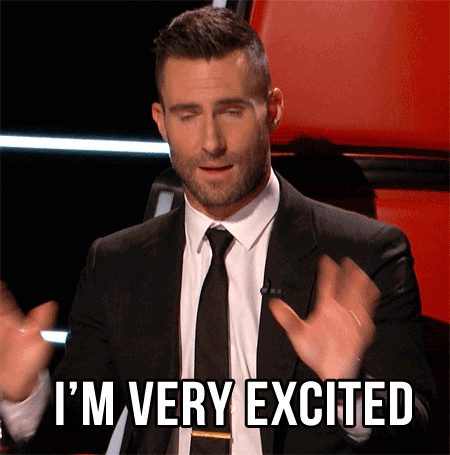 Celebrity gif. Wearing a suit and tie, Adam Levine gestures eagerly and says, “I'm very excited.”