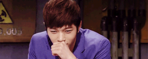 Celebrity gif. Kim Myung-Soo leans onto his fist pensively, then looks embarrassed and covers his face with his hands.