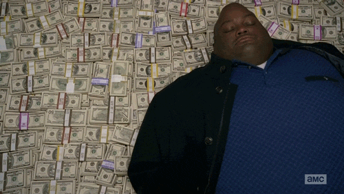 TV gif. Lavell Crawford as Huell on Breaking Bad. He is laying supine on a stacks of money and he rolls his head and shoulders around, trying to get comfortable.
