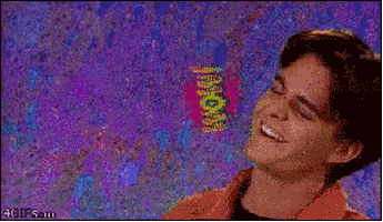 Video gif. A 90s era shot and font of a young man smiling and tilting his head as the text, "Wow," spins out behind him.
