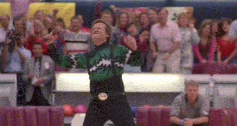 Movie gif. Bill Murray as Ernie in Kingpin celebrates, pelvic thrusting with his arms up victoriously as a crowd cheers behind him.