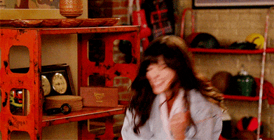 TV gif. Zooey Deschanel as Jessica in New Girl gives an energetic fist pump as she cheers excitedly. 