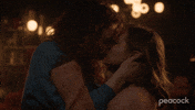 TV gif. From Vampire Academy, Rhian Blundell as Meredith holds Mia McKenna-Bruce as Mia's head in her hands, sharing a sultry kiss.