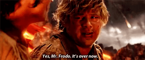 Movie gif. Sean Astin as Samwise Gamgee in The Lord of the Rings is dirty and tired looking. He looks over at Elijah Woods as Frodo with a defeated expression as they sit on the side of a mountain with lava and fireballs falling through the sky. Samwise says, “Yes, Mr. Frodo. It’s over now.”