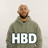 Video gif. Brian Kelleher, a UFC fighter, holds his hands up with a pleasant manner and mouths "Happy Birthday" to us in front of a beige background. Text, "HBD."