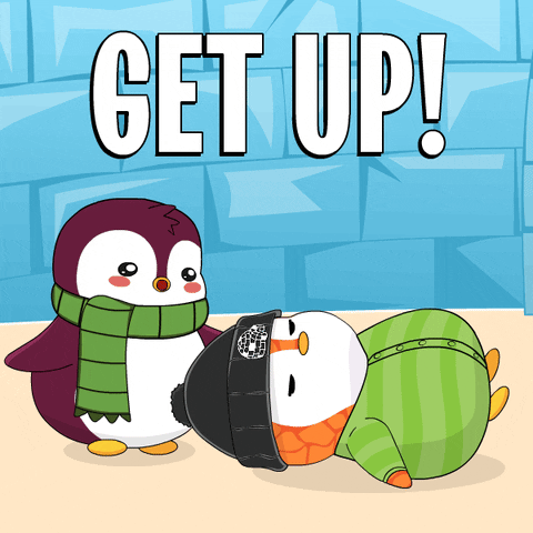 Cartoon gif. A purple penguin wrapped in a green scarf struggles to lift the head of a sleeping orange penguin in a black beanie and striped green pajamas. The orange penguin yelps as their sleep is disturbed. Text reads, "Get up!" 