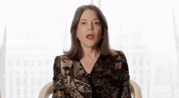 Political gif. Marianne Williamson is sitting on a chair and is being interviewed. She looks at us with a serious expression as she says, “I read a quote the other day that said sunsets are proof that endings can be beautiful too.”