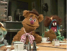 Muppets gif. Fozzie Bear drops his head into his hand, covering his eyes and looking annoyed. 