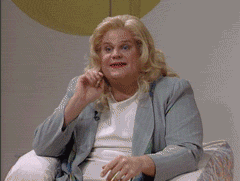SNL gif. Chris Farley is dragged in drag and he sexily combs through his long blonde hair with his hands.