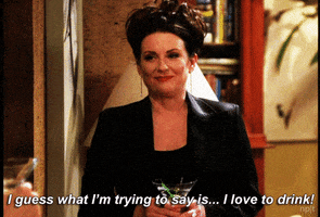 TV gif. Megan Mullally as Karen Walker from Will & Grace looks classy, dressed in a professional blazer with her hair in an updo. She holds a martini glass and forces out a pained laugh while saying, "I guess what I'm trying to say is... I love to drink!"