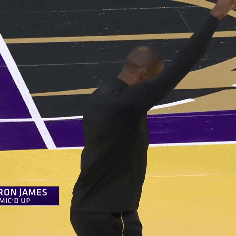 Sports gif. Lebron James in street clothes holds one fist up and the other at his low back as he thrusts his hips and jumps forward with each thrust. 