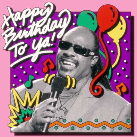 Digital compilation gif. Black and white photo of Stevie Wonder singing into a microphone as animated colorful graphics like balloons, musical notes, and confetti flash around him. Text, "Happy Birthday to ya!'