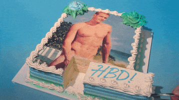 Video gif. White cake with an image of a naked man on it. The cake is cut right at the crotch of the man. Someone is taking that piece of cake, moving it back and forth into place. The piece of cake says, “HBD!”