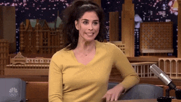 Tonight Show gif. Sarah Silverman shrugs her shoulders and raises her arms at odd angles, making a silly facial expression. Text reads, "I don't know?"