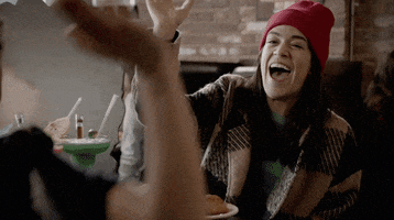 TV gif. Ilana Glazer and Abbi Jacobson in Broad City. They're sitting at lunch and are extremely pleased with themselves as they do a high five of pride.