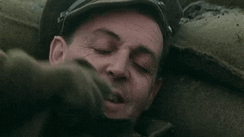 Music video gif. Paul McCartney in his music video for Pipes of Peace. He's wearing an old school military outfit and is snuggled up in a trench as he's about to fall asleep. Text, "Nap time."