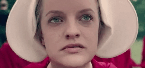 Elisabeth Moss as Offred in Teh Handmaid's Tale closes her eyes 