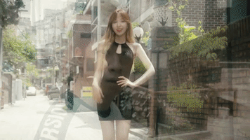 Celebrity gif. Wendy of the Korean girl group Red Velvet wears a nice black dress on a street. She waves at us and flips her hair, the hair flip seen again in a close up before she also tilts her head at us while smiling.