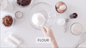 Video gif. Looking down at a mixing bowl one at a time, a hand sprinkles various items into the bowl and then stirs them together. Text, "Flour, baking soda, salt"