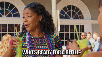 Movie gif. Tiffany Haddish as Gina in Girls' Trip. She shakes her empty cup and says, "Who's ready for a refill?!" while hyping the girls up.