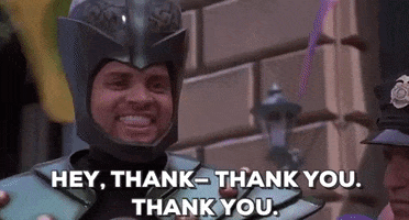 Movie gif. A Jingle All the Way character in an elaborate villain costume complete with a helmet with a brain submerged in water nods with an appreciative smile. He says, “Hey, thank–thank you. Thank you.”