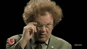 TV gif. John C Reilly as Dr. Steve Brule in Check it out takes off his glasses and eagerly winks.